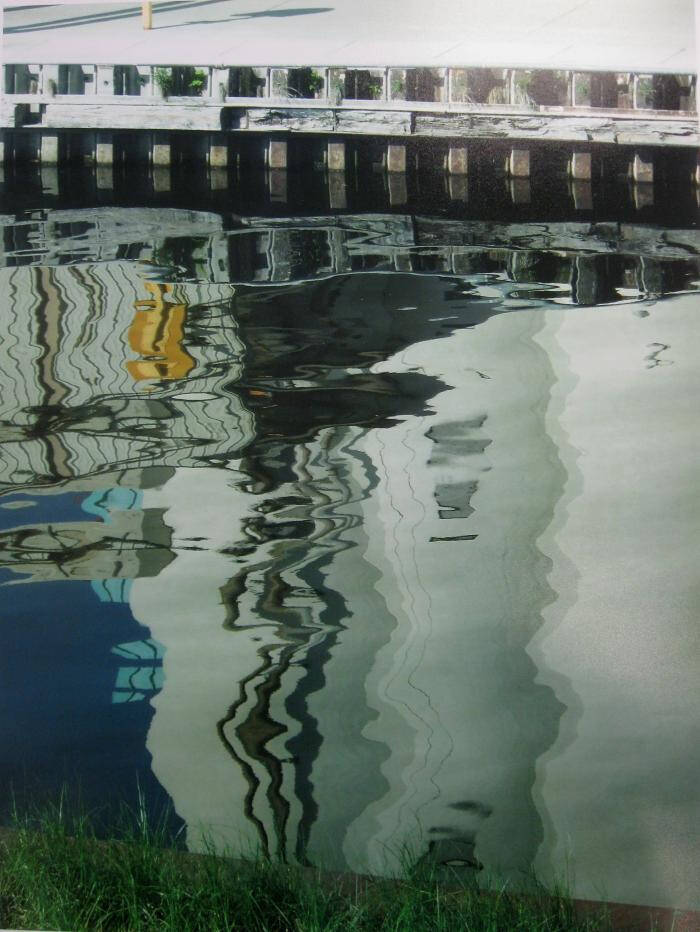 A photograph of water reflecting a building.